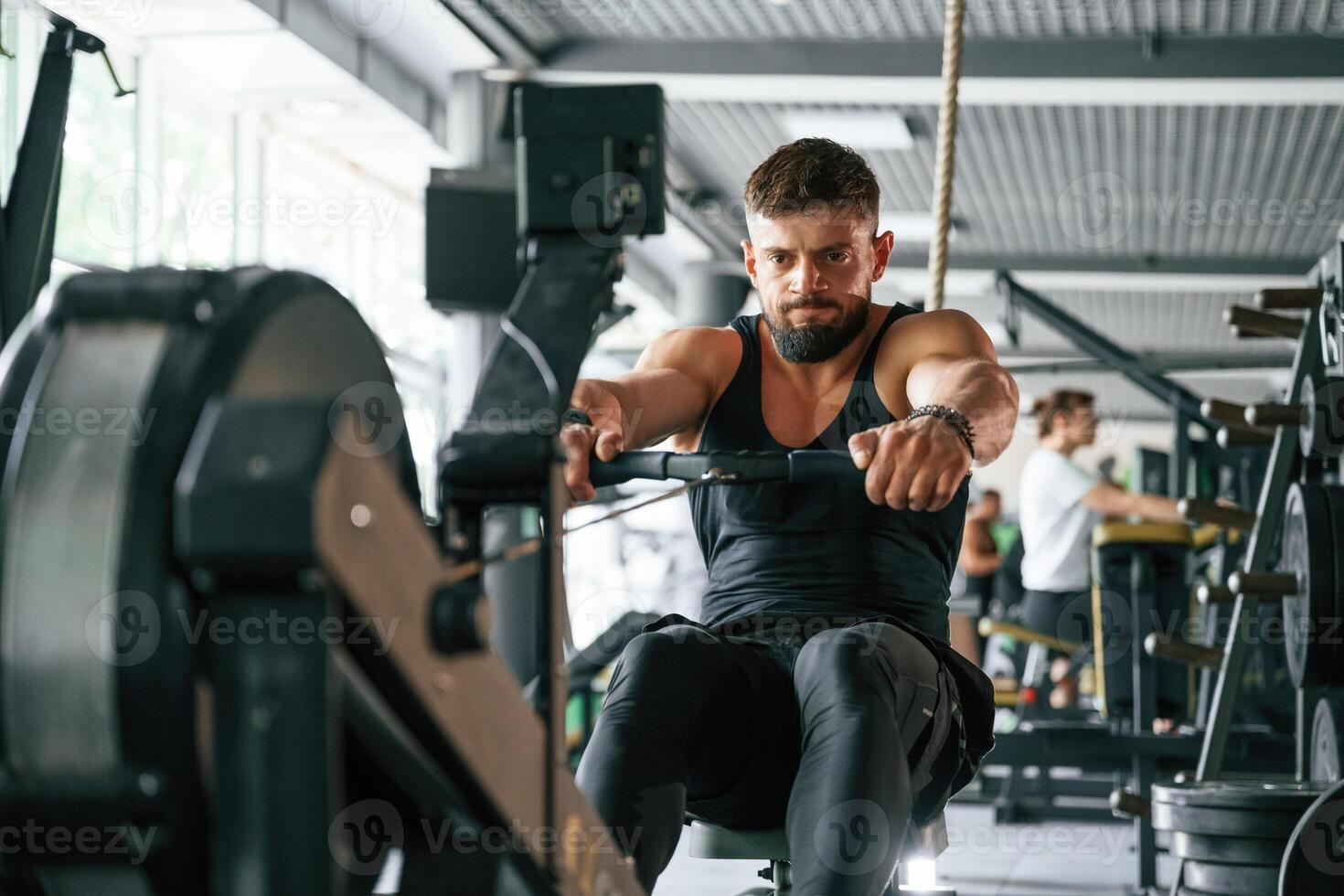 Exercise for stamina.. Strong muscular man is working out in the gym photo