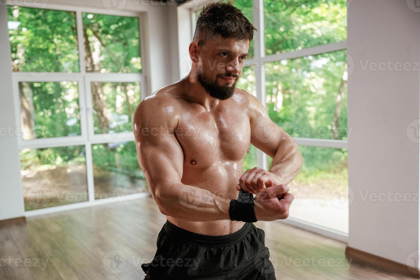 Wearing the, protective bandage on hands. Strong muscular man is working out in the gym photo