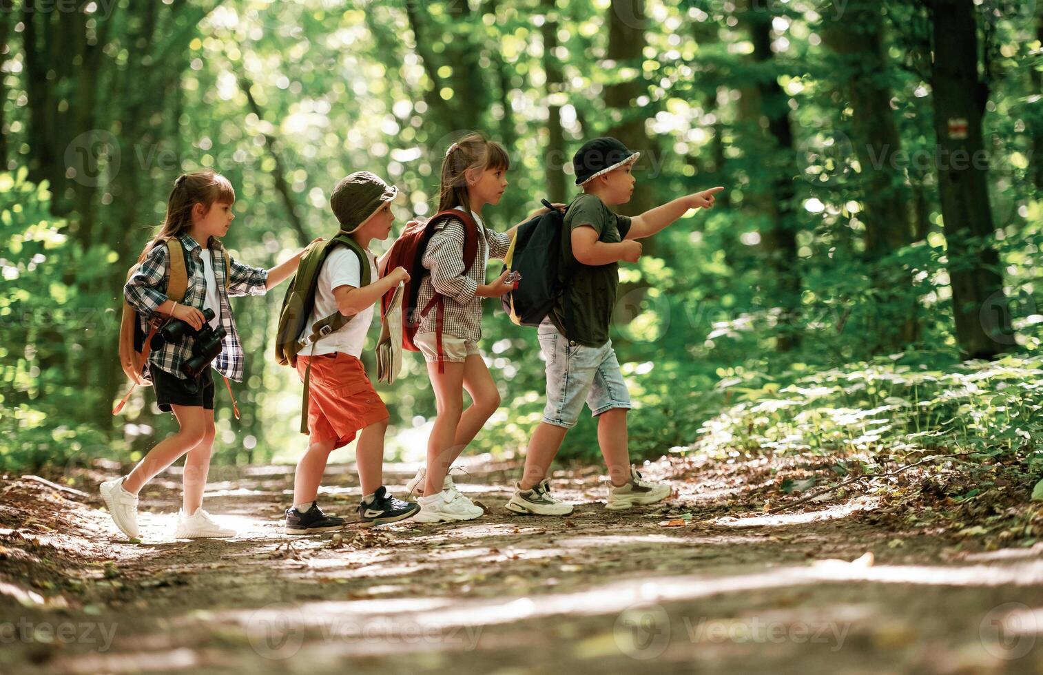 Going, to, the, side. Kids in forest at summer daytime together photo