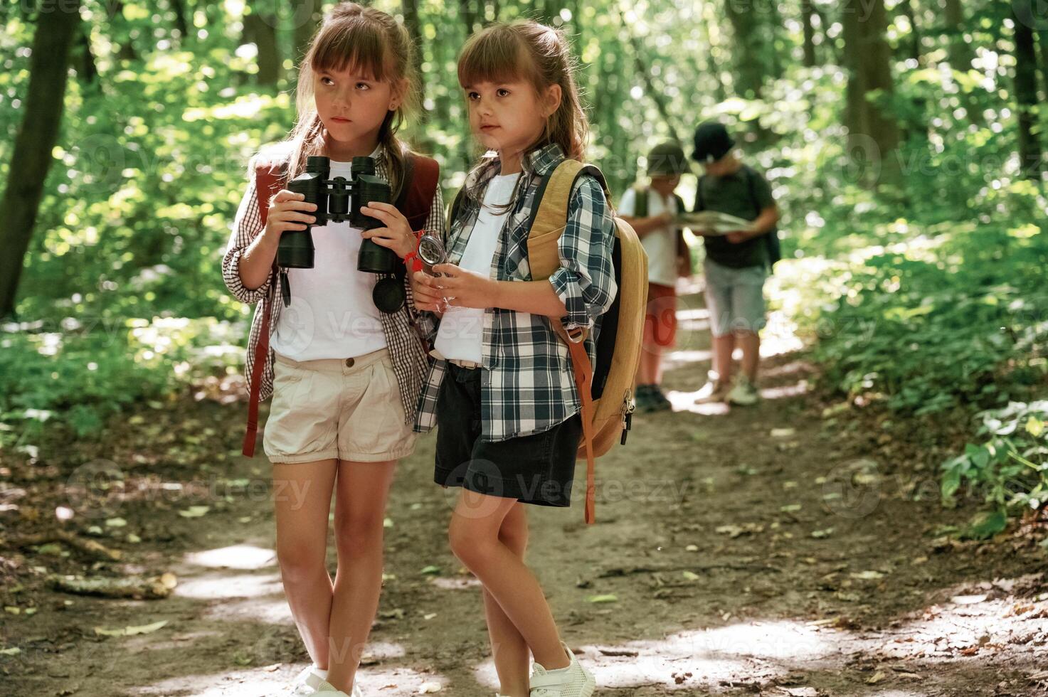 Using binoculars,. Kids, in forest at summer ,,daytime together photo