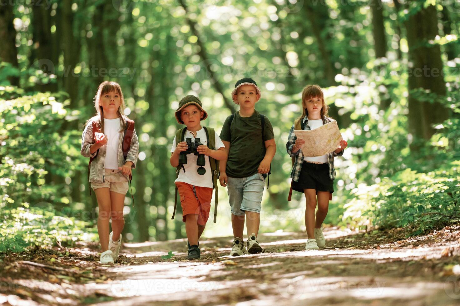 Conception of hiking.. Kids in forest at summer daytime together photo