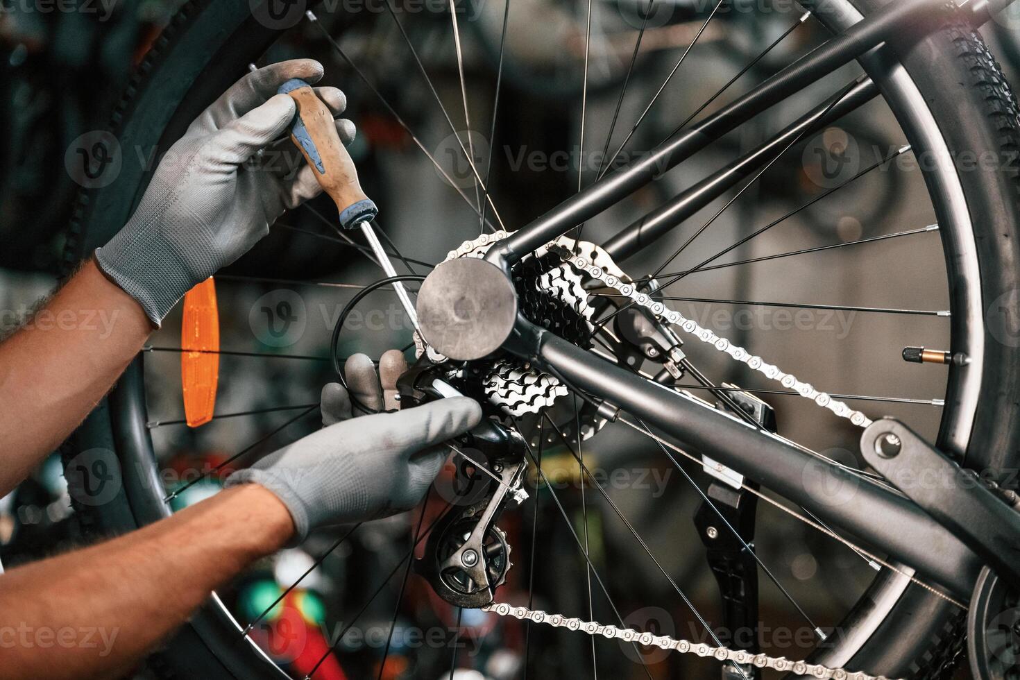 Fixing, the, derailleur.... Close ,,up view of man's hands that is repairing bicycle photo