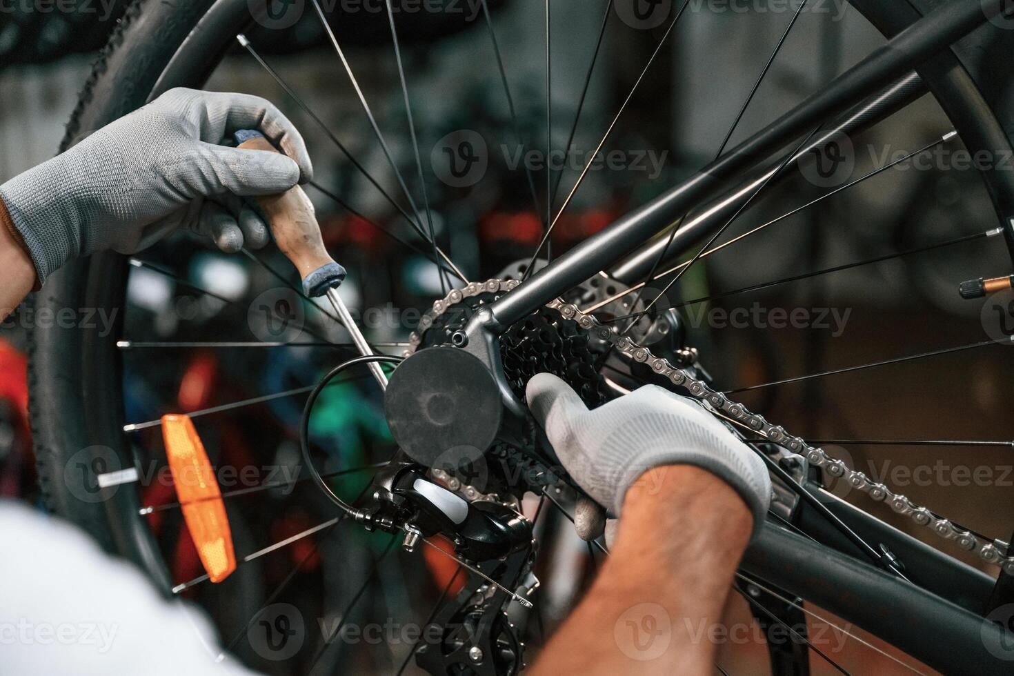 The derailleur issue, fixing. Close up view of man's hands that is repairing bicycle photo