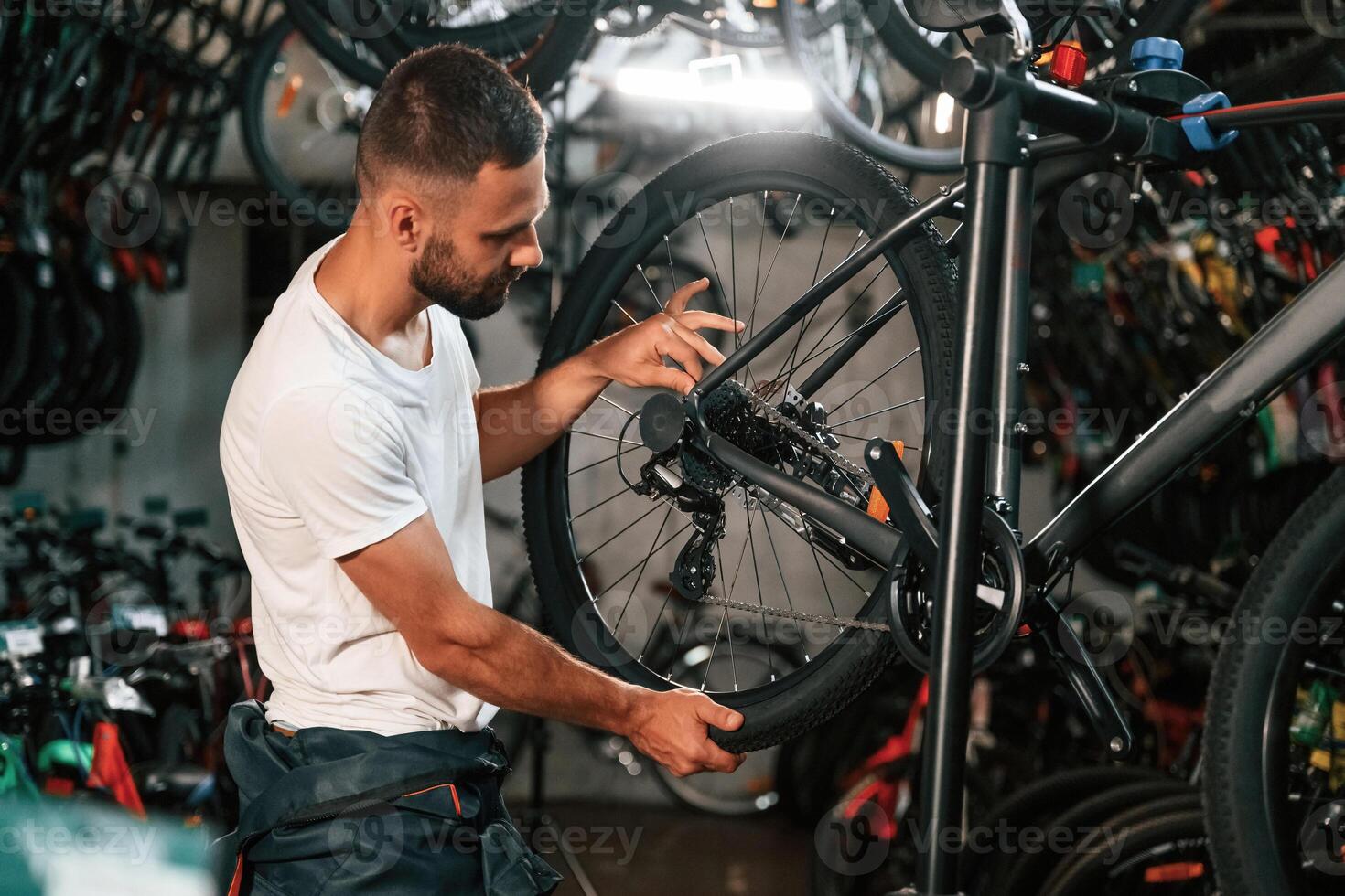 Working in the store. ,,Repair man in bicycle shop photo
