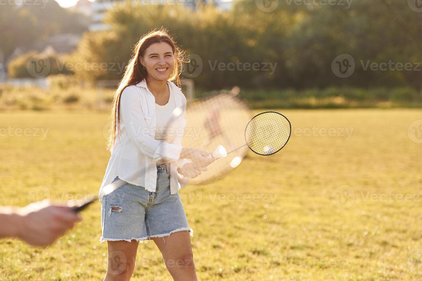 On the summer field. Man with woman are playing badminton photo