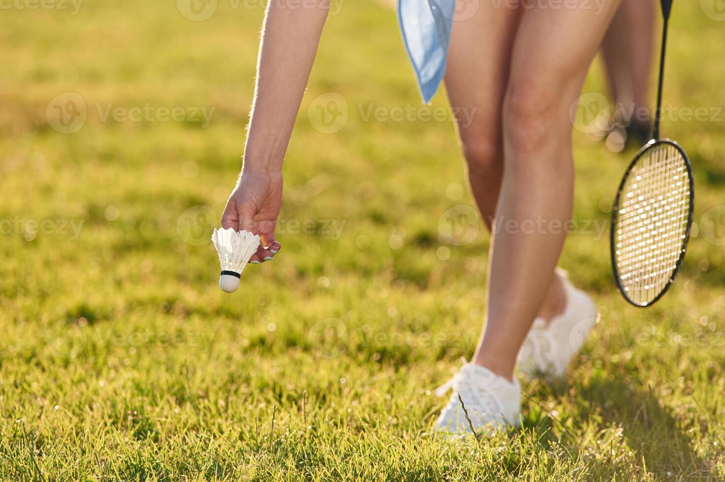 Close up, view, of ,,woman that is taking shuttlecock from the ground photo