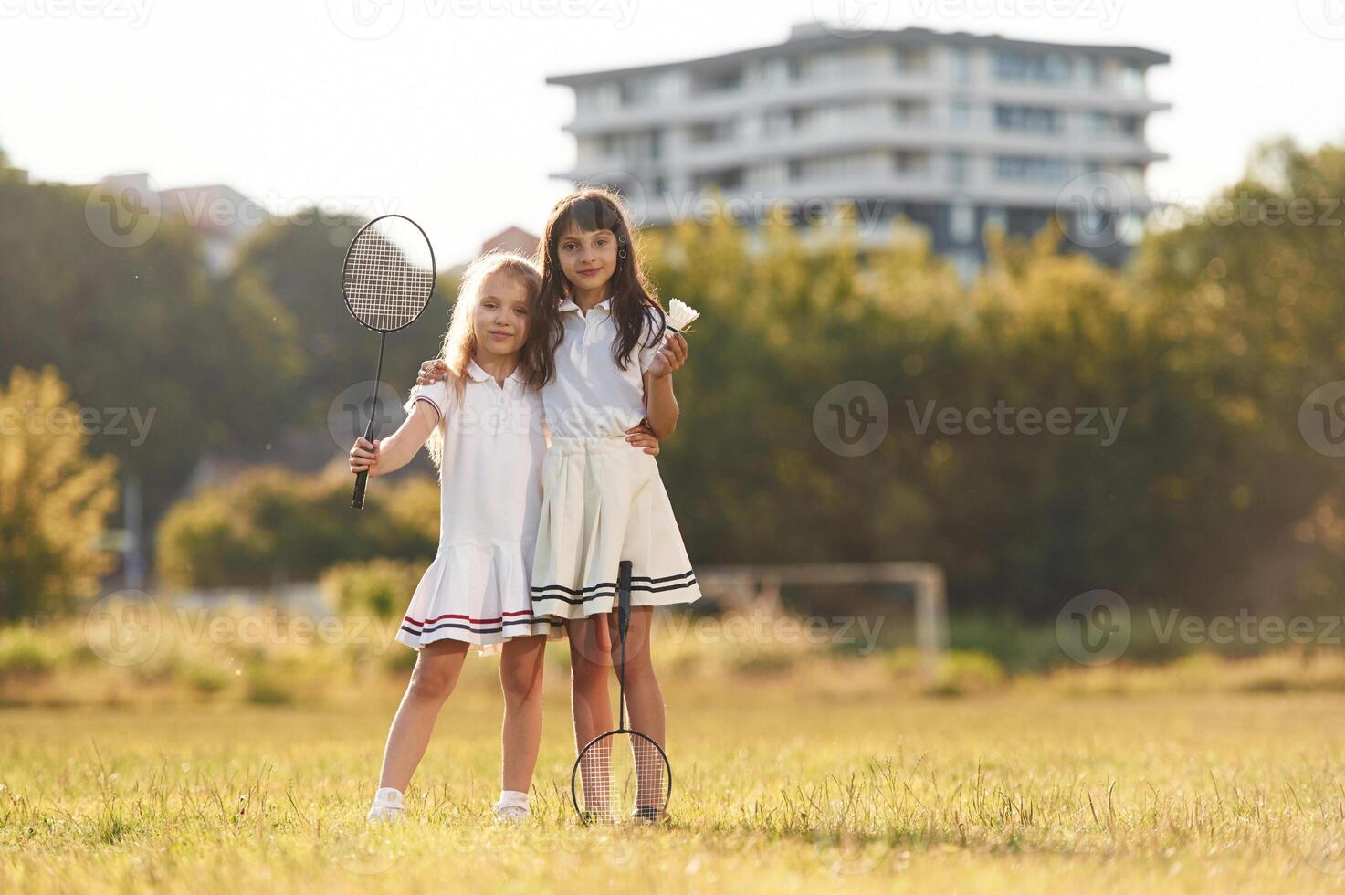 Girls are standing and posing., Happy kids are on the summer field photo