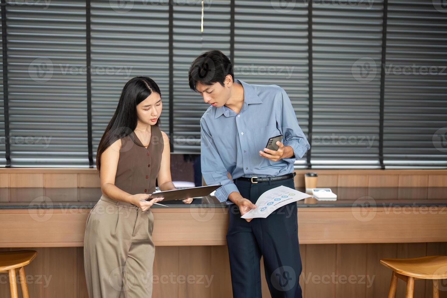 Business Meeting and Analysis. Professionals reviewing reports and discussing strategies in an office. photo