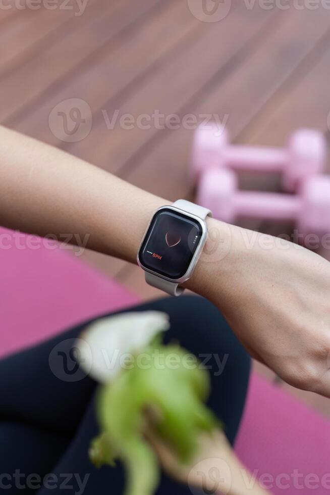 Yoga and Fitness Tracking. Close-up of smartwatch displaying health metrics during workout. photo