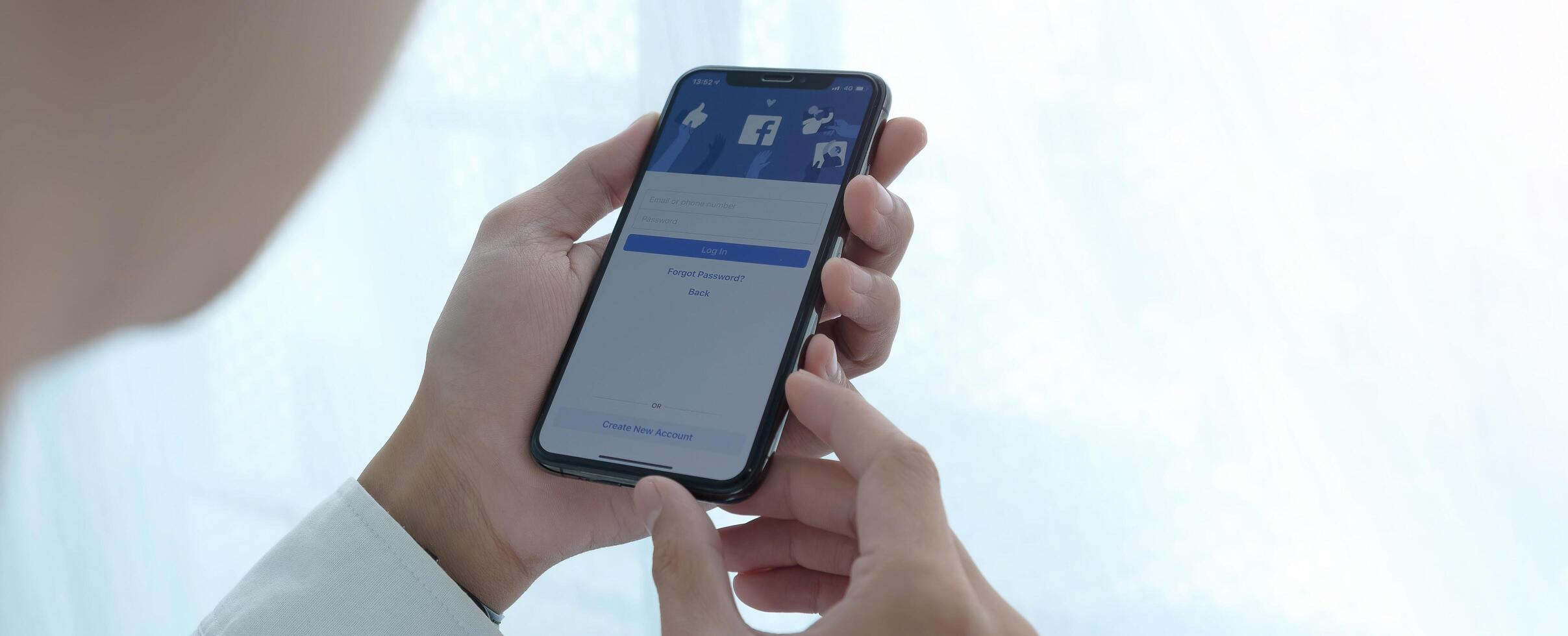 CHIANG MAI, THAILAND, JUL 27, 2020 . Facebook social media app logo on log-in, sign-up registration page on mobile app screen on iPhone smart devices in business person's hand at work photo