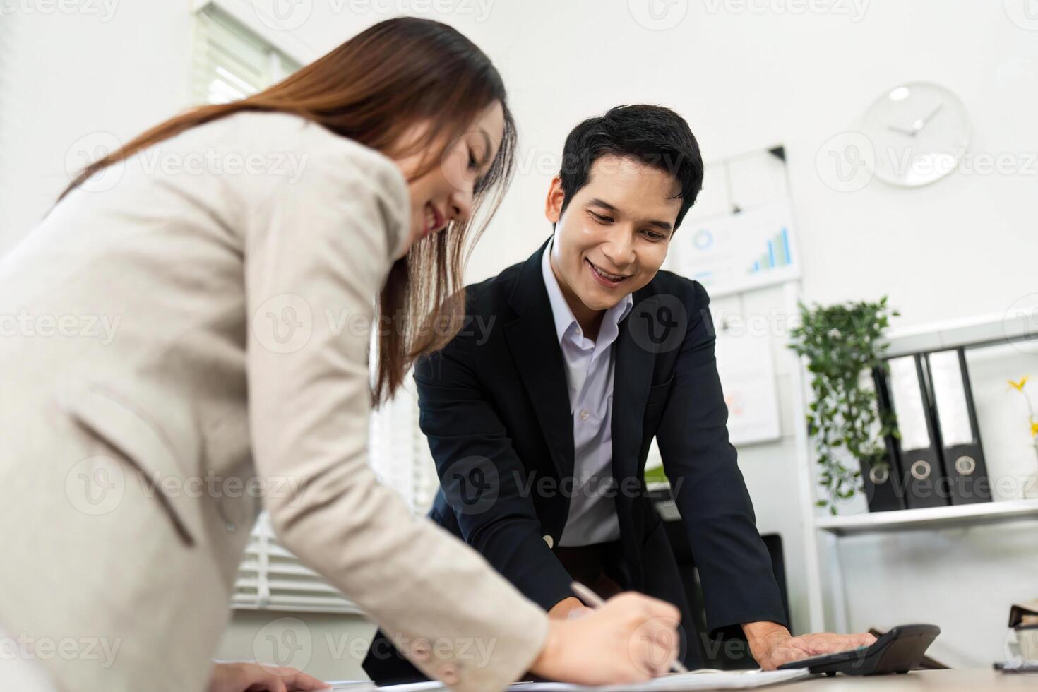 Collaborative Business Planning. Professionals working together on financial documents and strategies in an office. photo