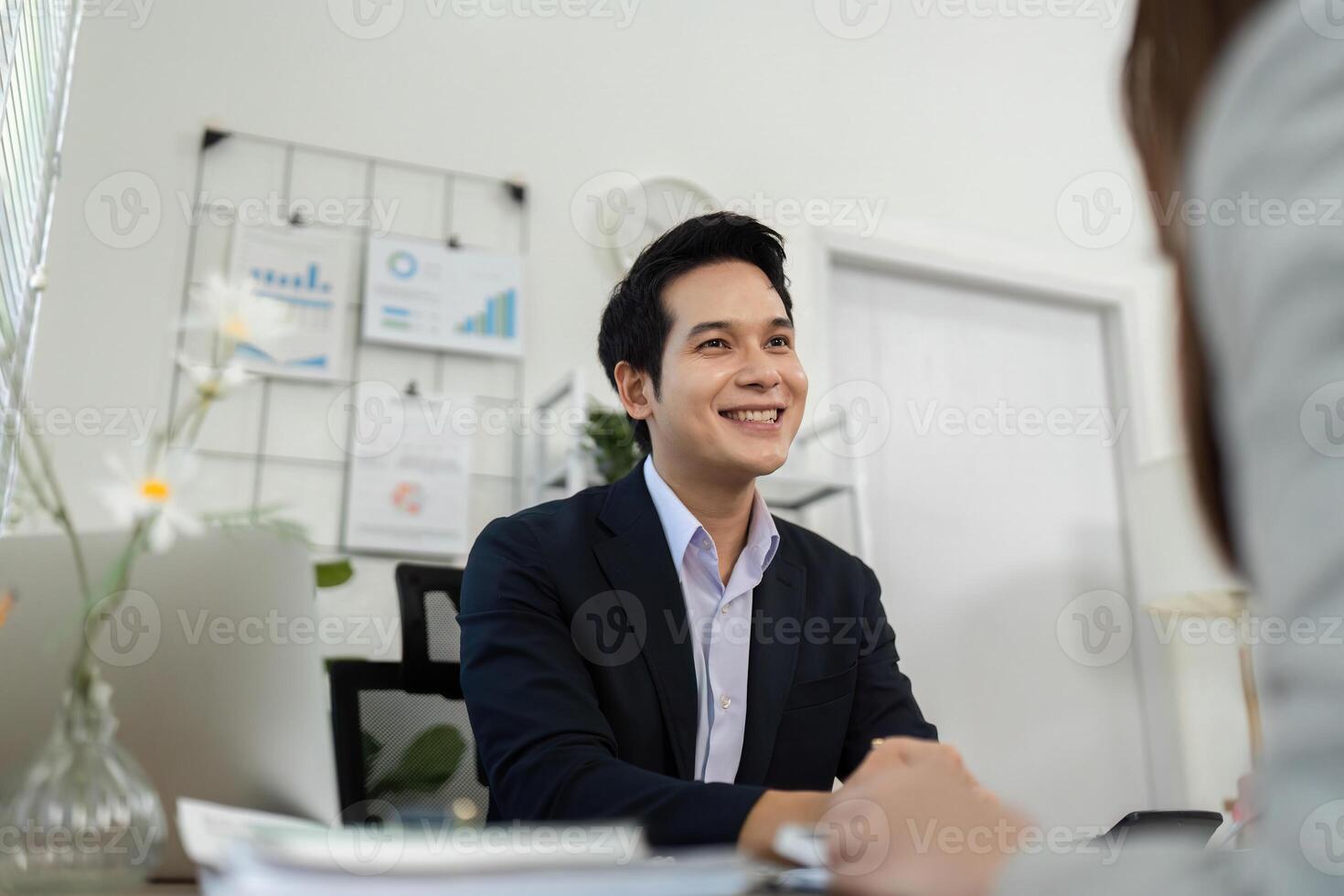 Positive Business Interaction. Consultant smiling while engaging with a client in a meeting. photo