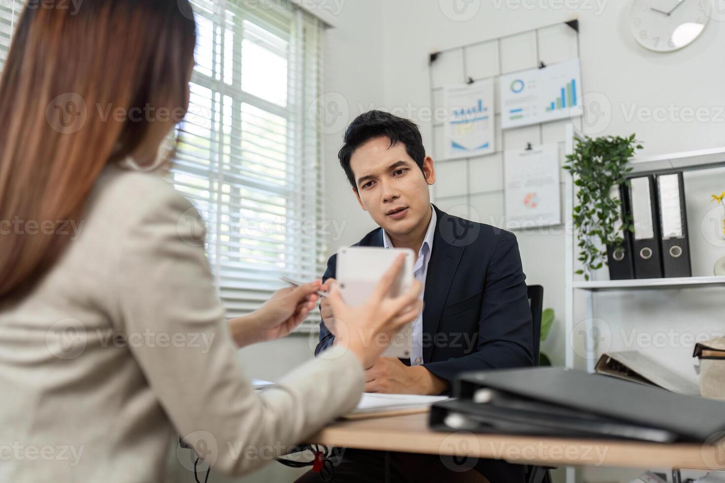 Business Consultation and Collaboration. Professional meeting between two colleagues discussing financial strategies. photo