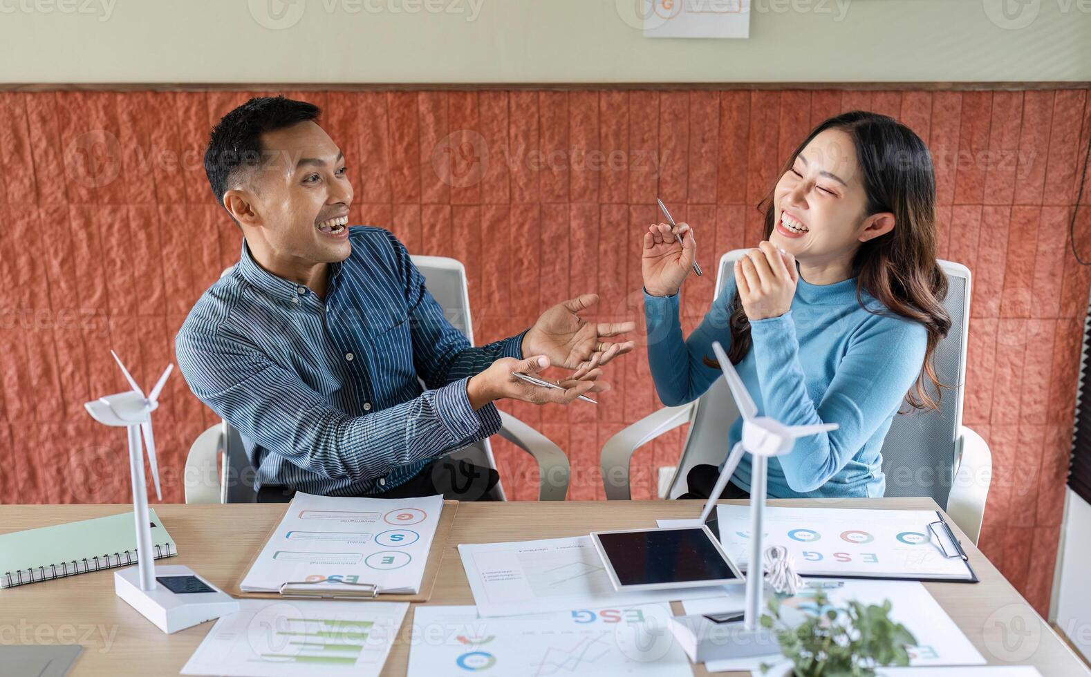 ESG Business Discussion. Two professionals engaging in a lively conversation about sustainable practices. photo