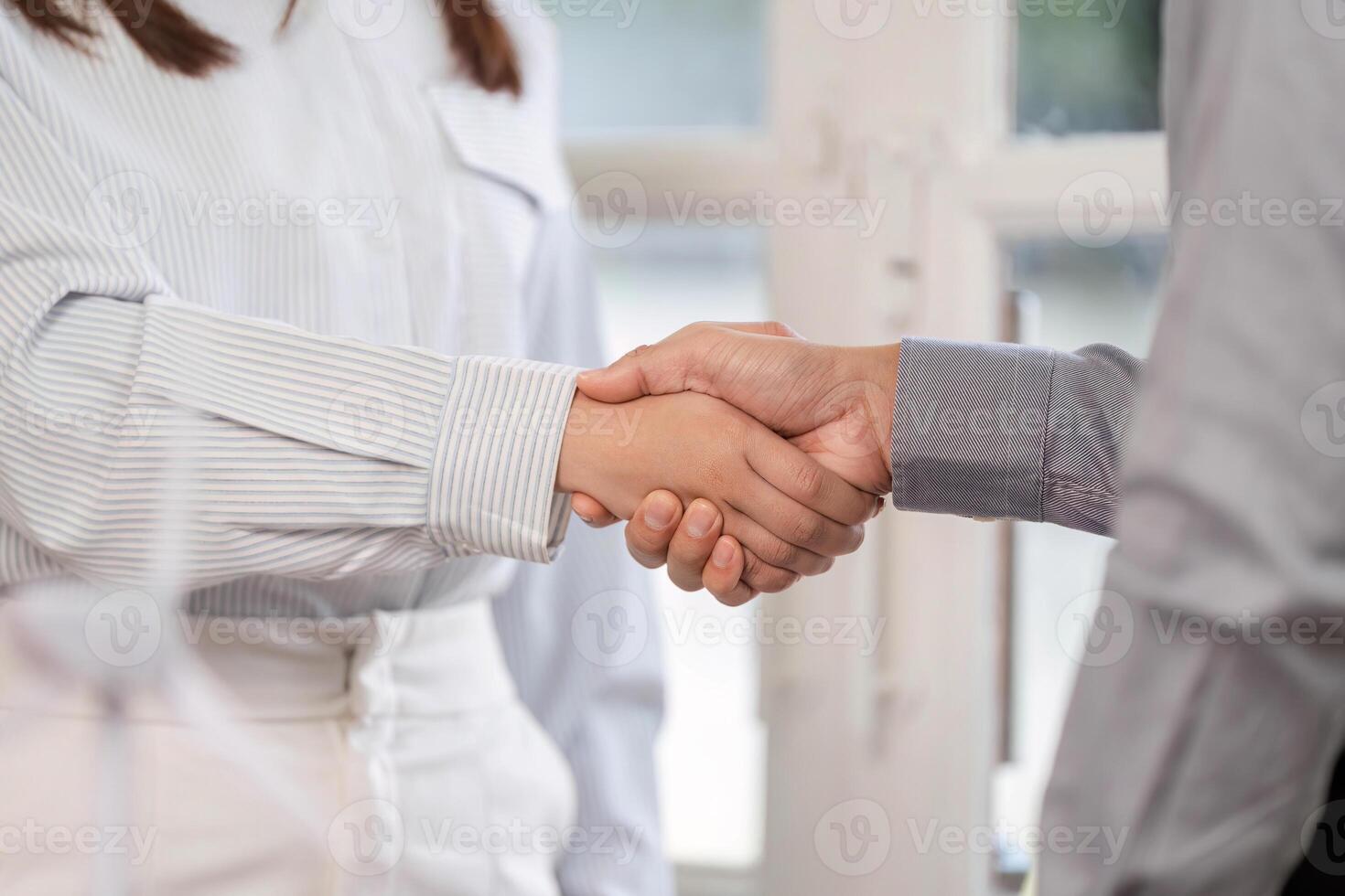 Business Agreement. Close-up of a handshake between two professionals in a bright office. photo