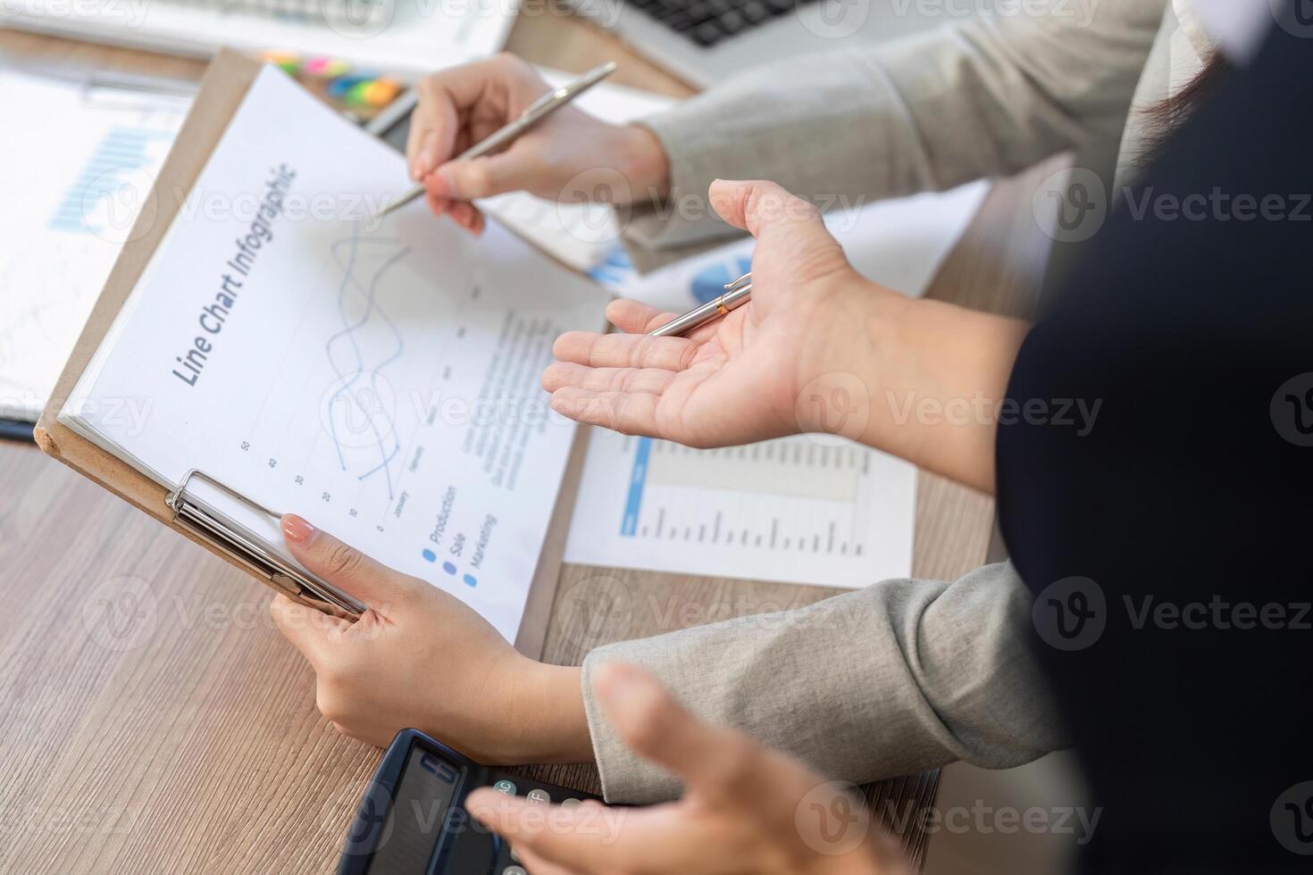 Financial Consultation and Collaboration. Business professionals discussing financial data in an office setting. photo