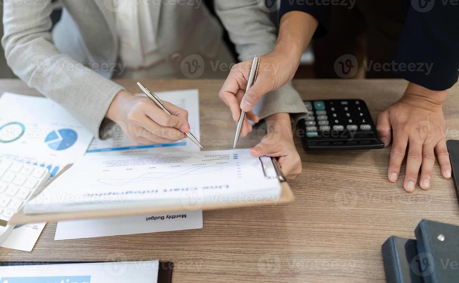 Detailed Financial Review. Professionals analyzing financial documents and discussing strategies in an office. photo