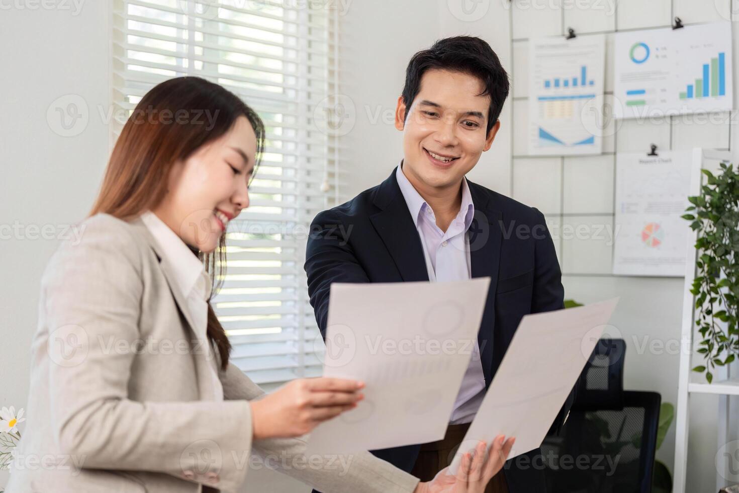Financial Document Review. Business partners sharing insights on financial reports in an office. photo