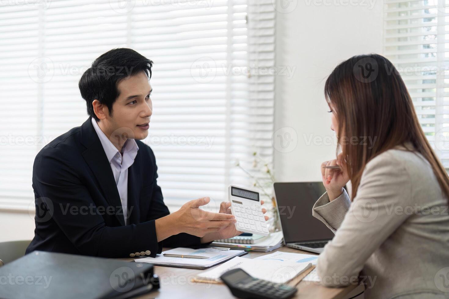 Financial Consultation Session. Advisor presenting financial data and strategies to a client. photo