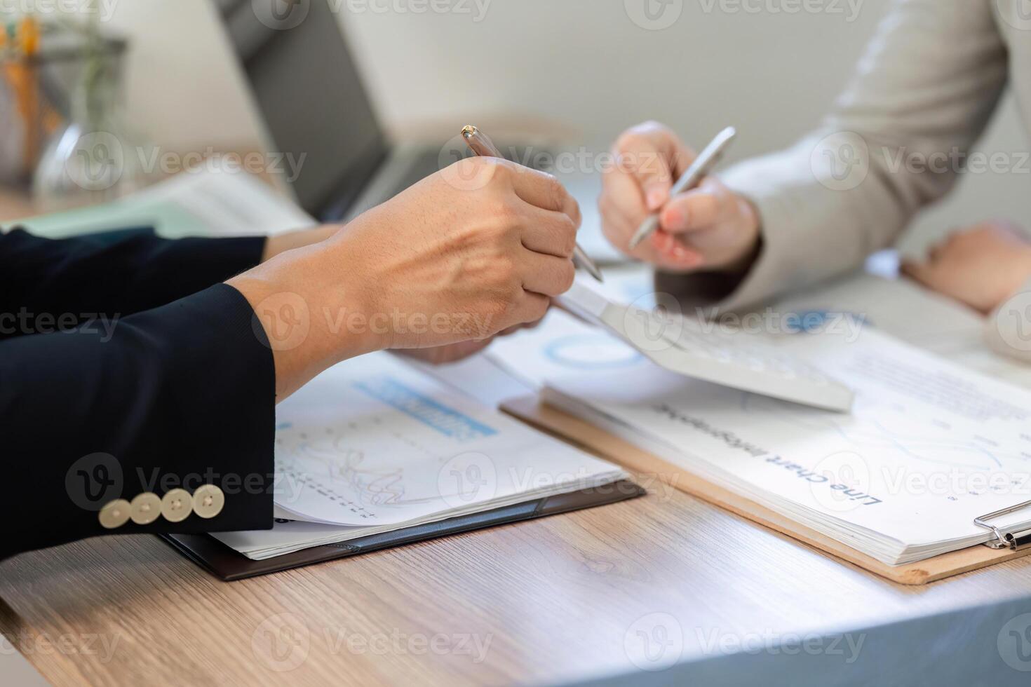 Hands in Financial Discussion. Professionals analyzing documents and strategies together. photo