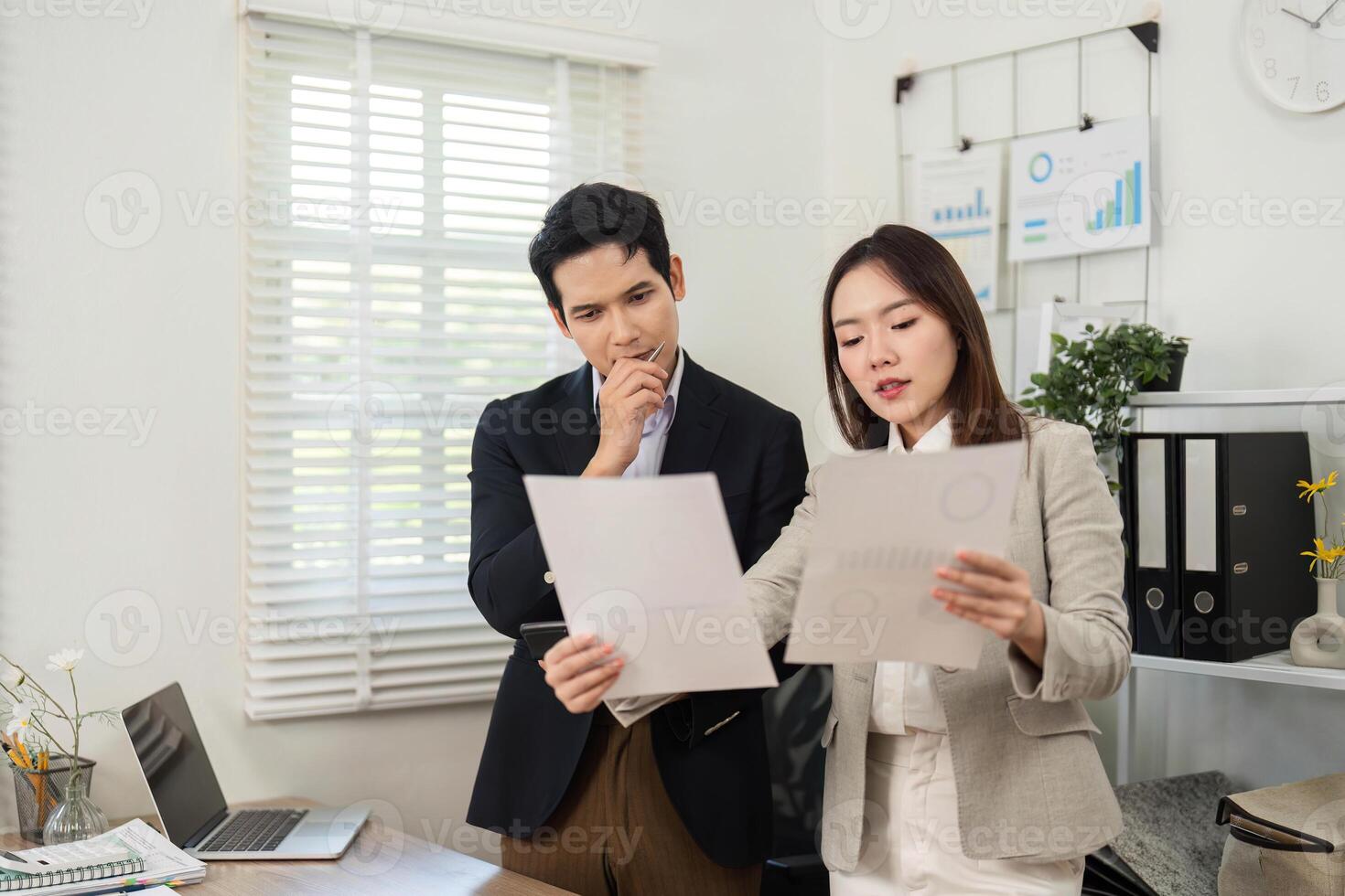 Business Collaboration and Strategy. Professionals analyzing project documents in modern office. photo