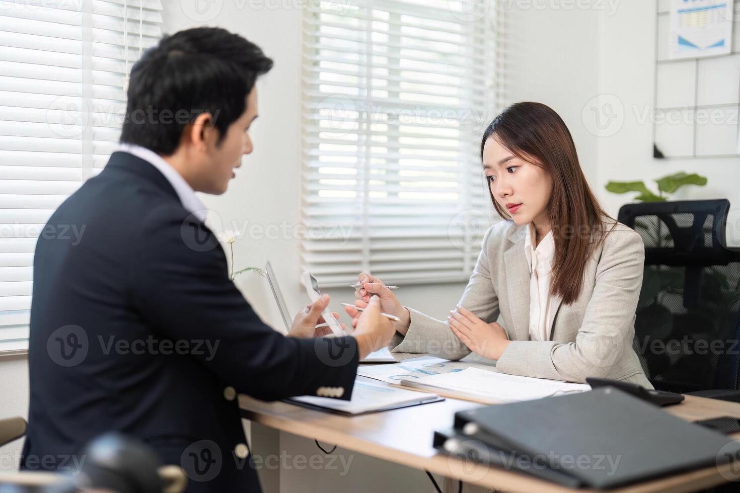 Professional Financial Meeting. Client and advisor discussing financial plans and goals. photo