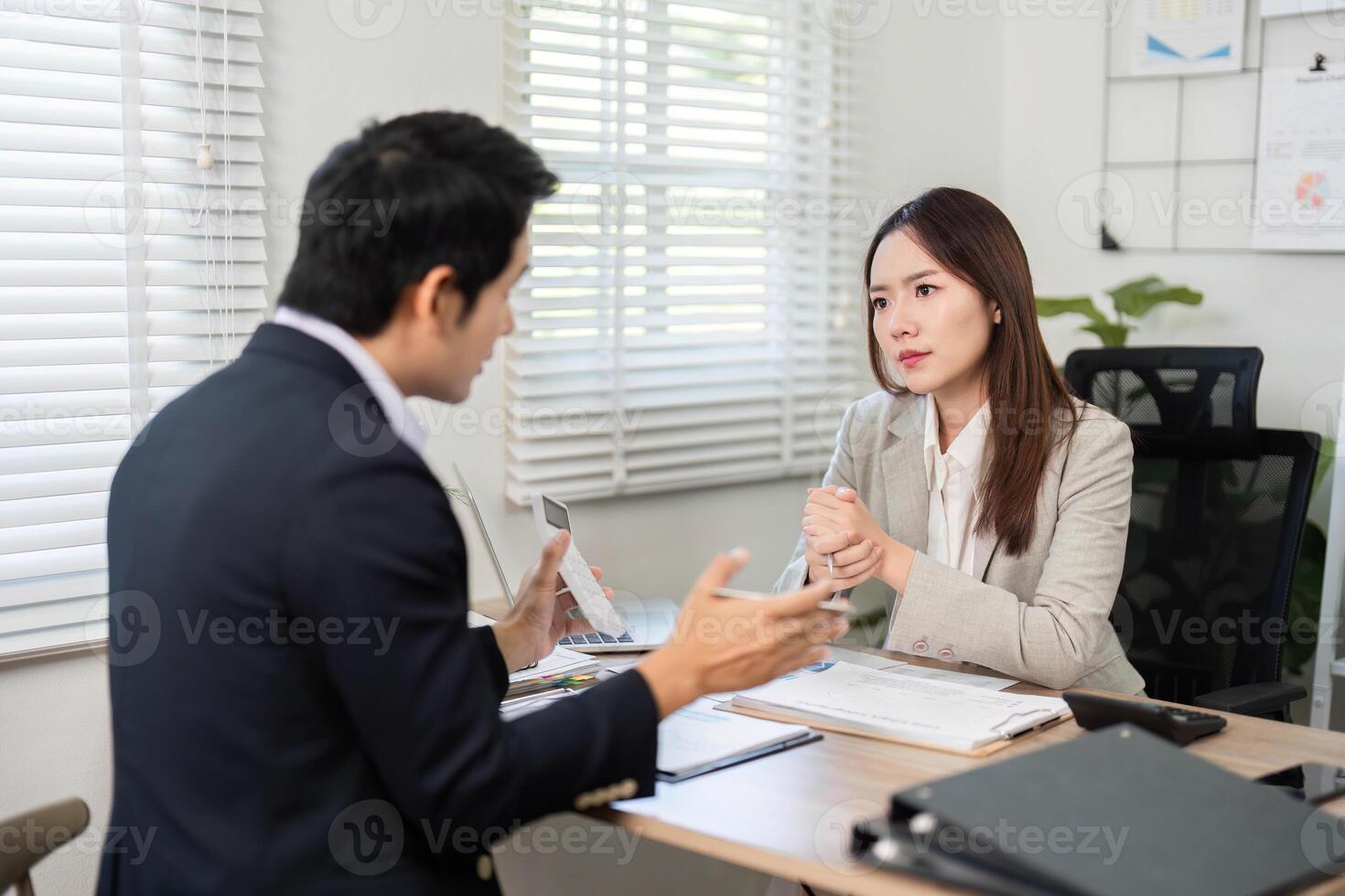 Investment Strategy Discussion. Financial advisor explaining investment options to a client. photo