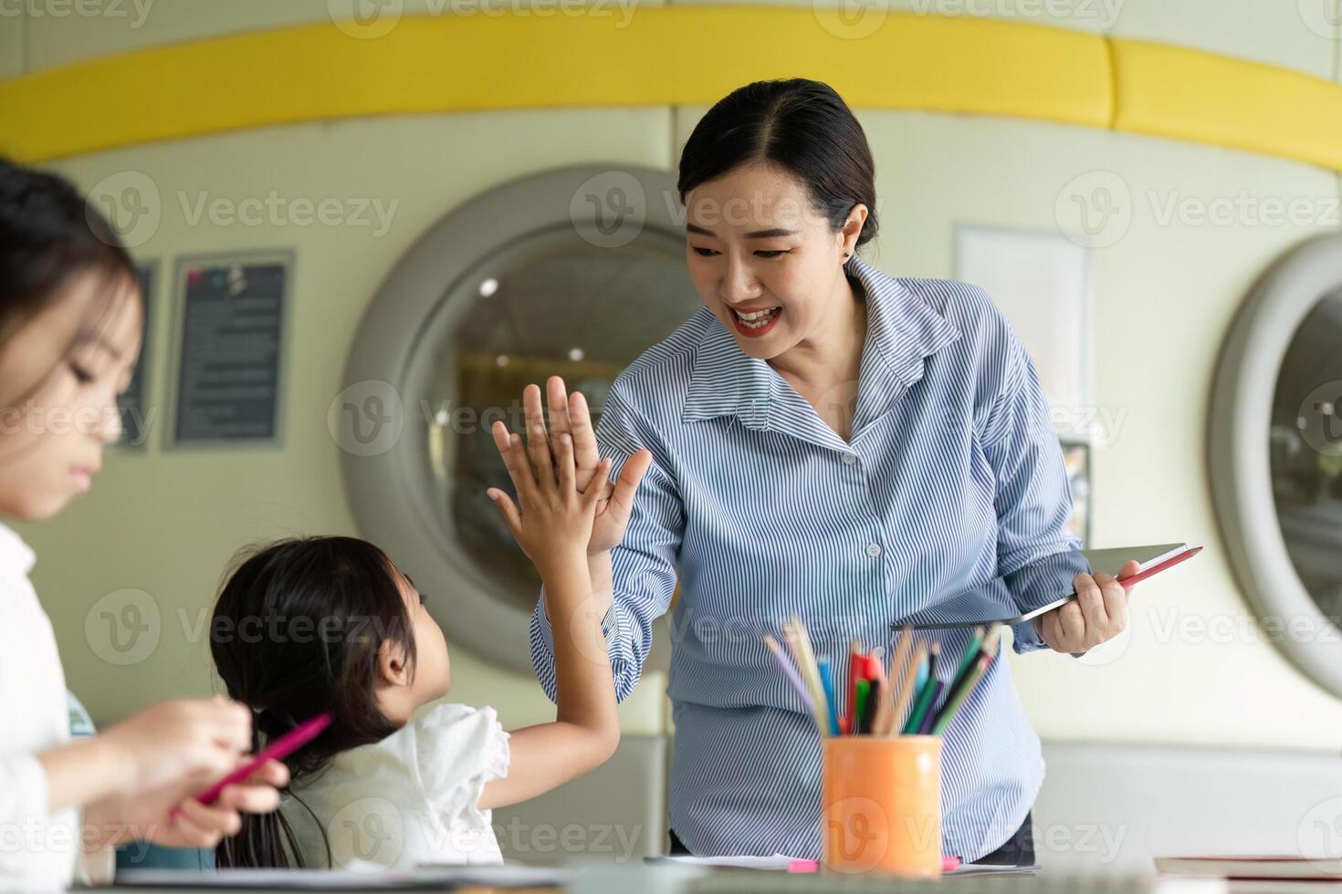 Back to School. Teacher celebrating a young girl's achievement in a vibrant classroom. photo