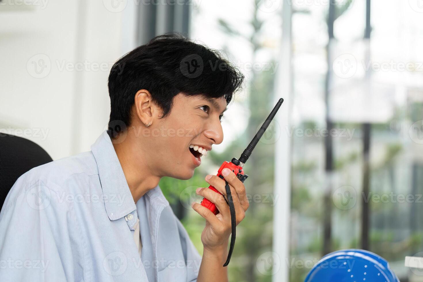 Communication in the Workplace. Engaged professional using a walkie-talkie. photo