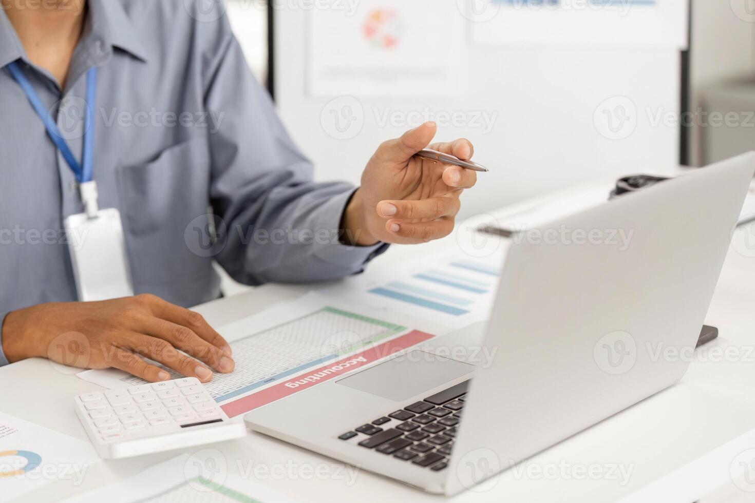 Remote Work and Digital Transformation. Professional analyzing data on laptop with documents. photo