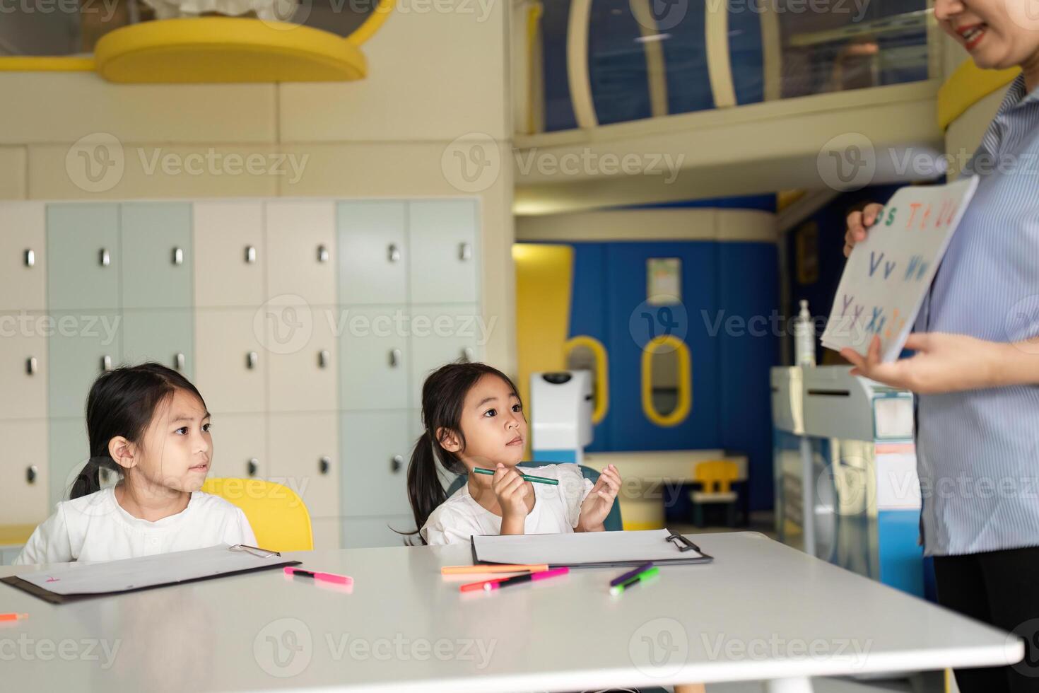 Back to School Learning. Engaging teacher interacting with students in a colorful classroom. photo