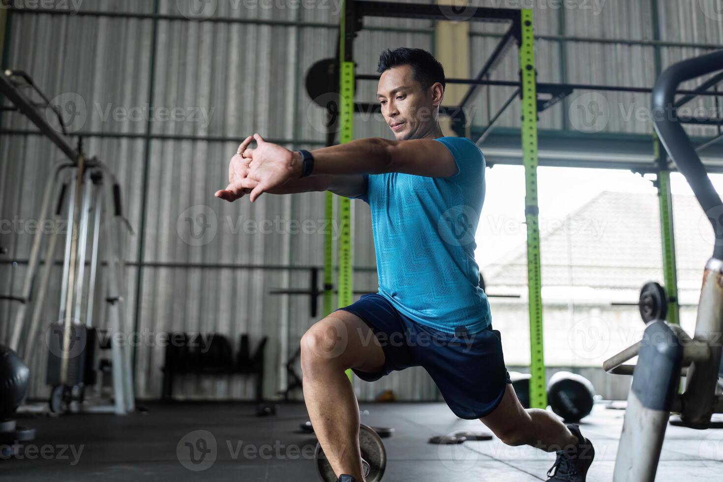 Fitness Training. Male athlete performing lunge exercise in gym. photo