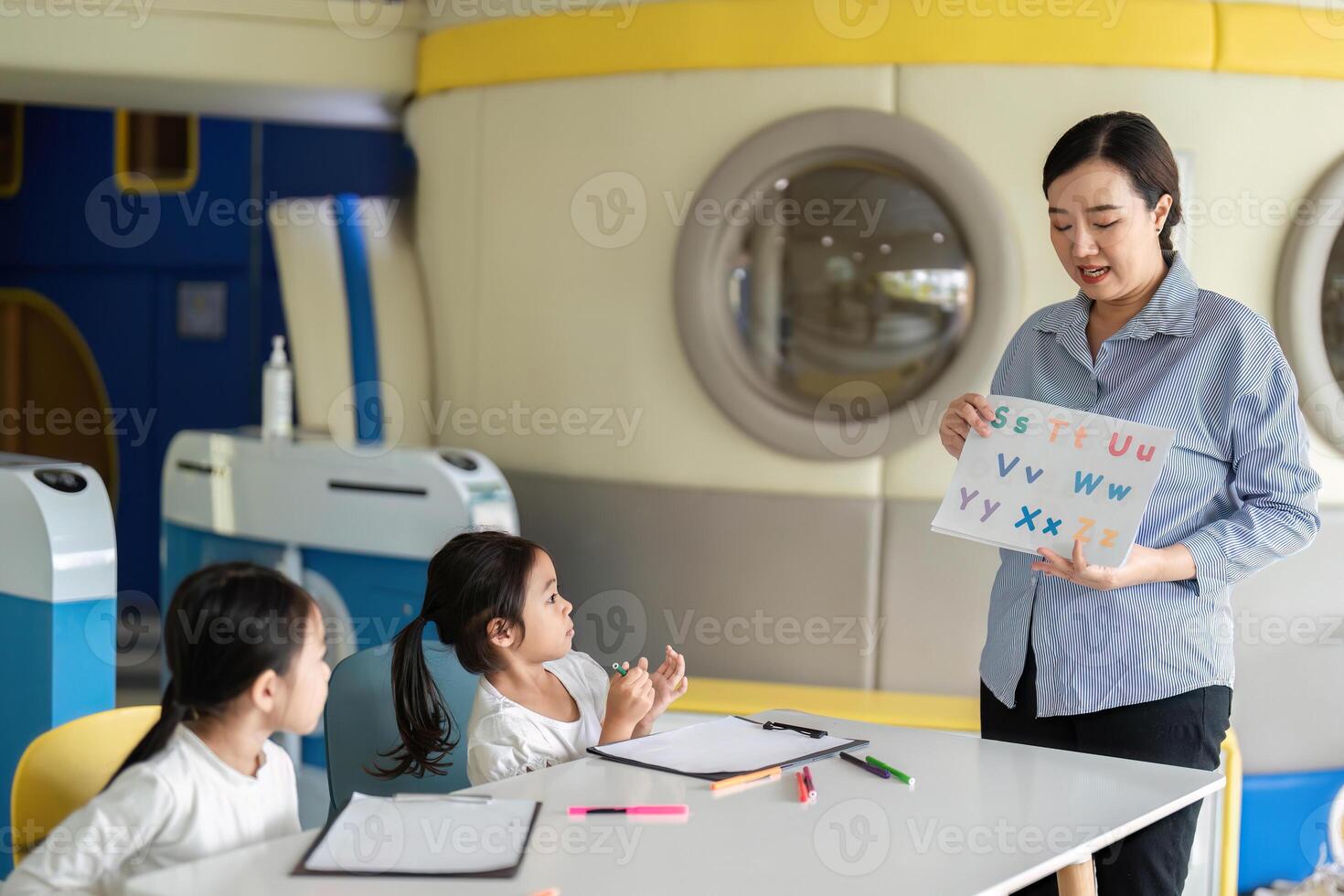 Back to School. Teacher using visual aids to enhance learning in a classroom. photo