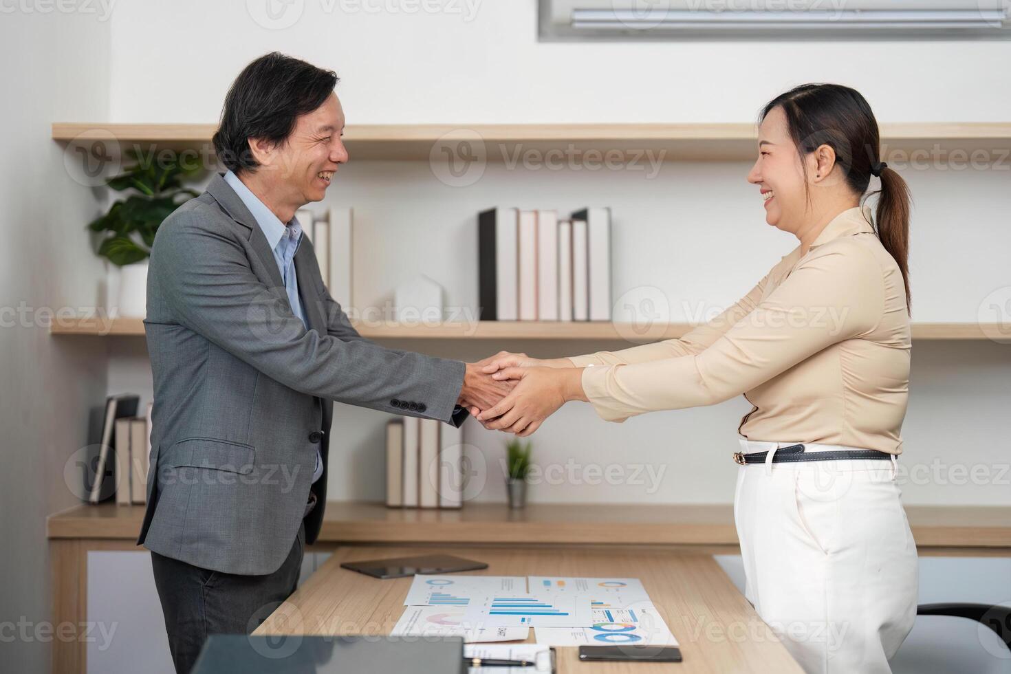 Business Collaboration and Partnership. Professionals shaking hands in a modern office. photo