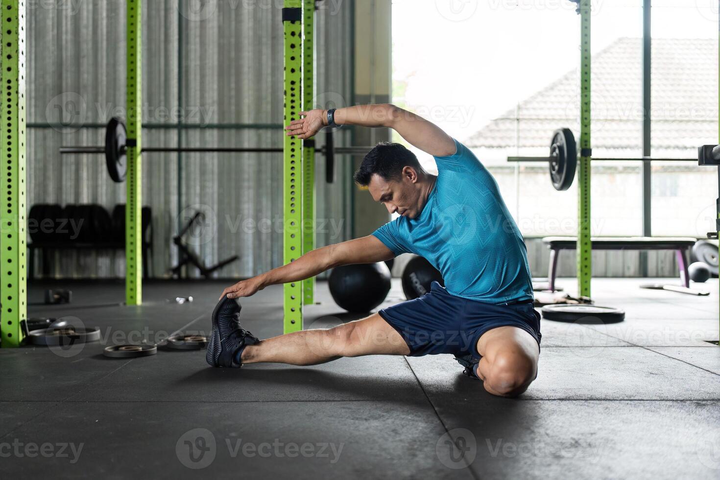 Fitness and Flexibility. Man stretching in a gym for improved mobility. photo