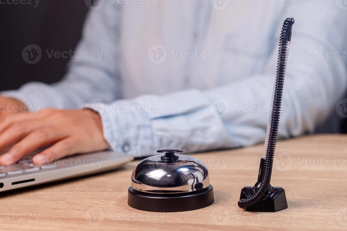 A service bell or call bell and a pen on the receptionist desk photo