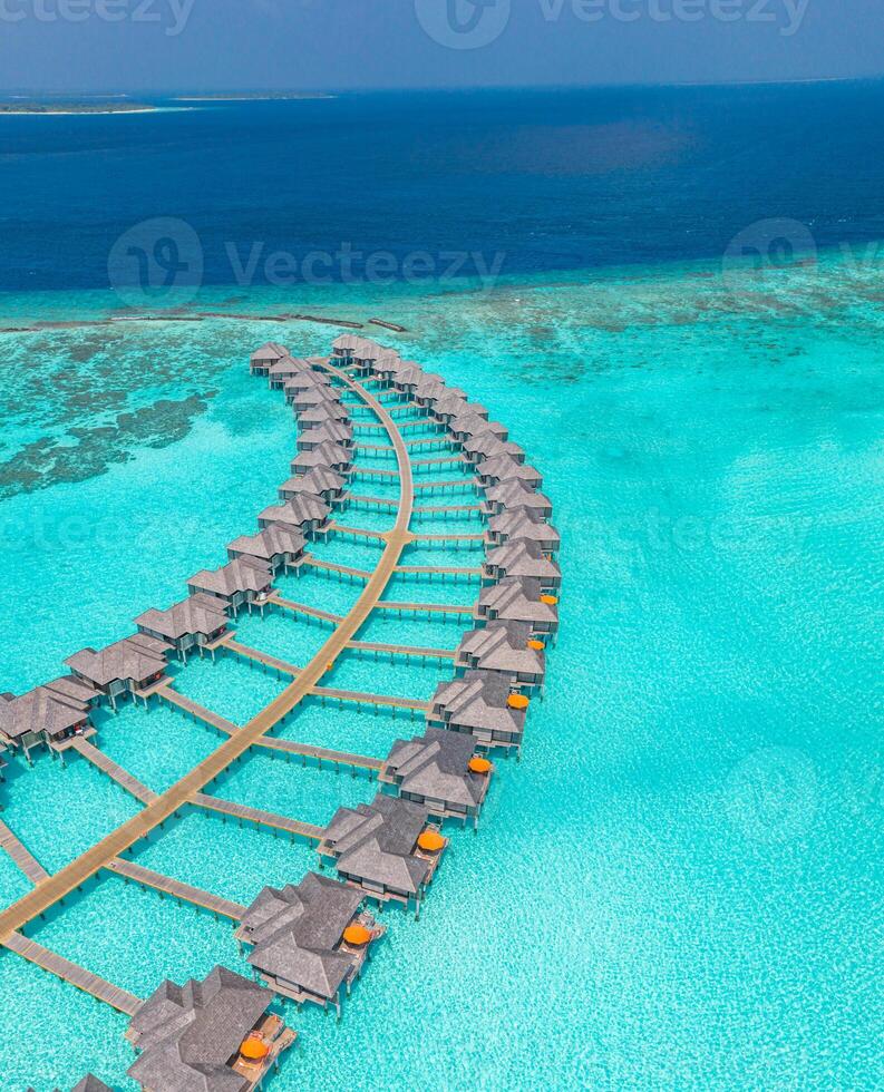 Stunning aerial view of Maldives luxury villas surrounded by turquoise lagoon and pristine white sand beaches offering a serene tropical paradise and exclusive island escape photo