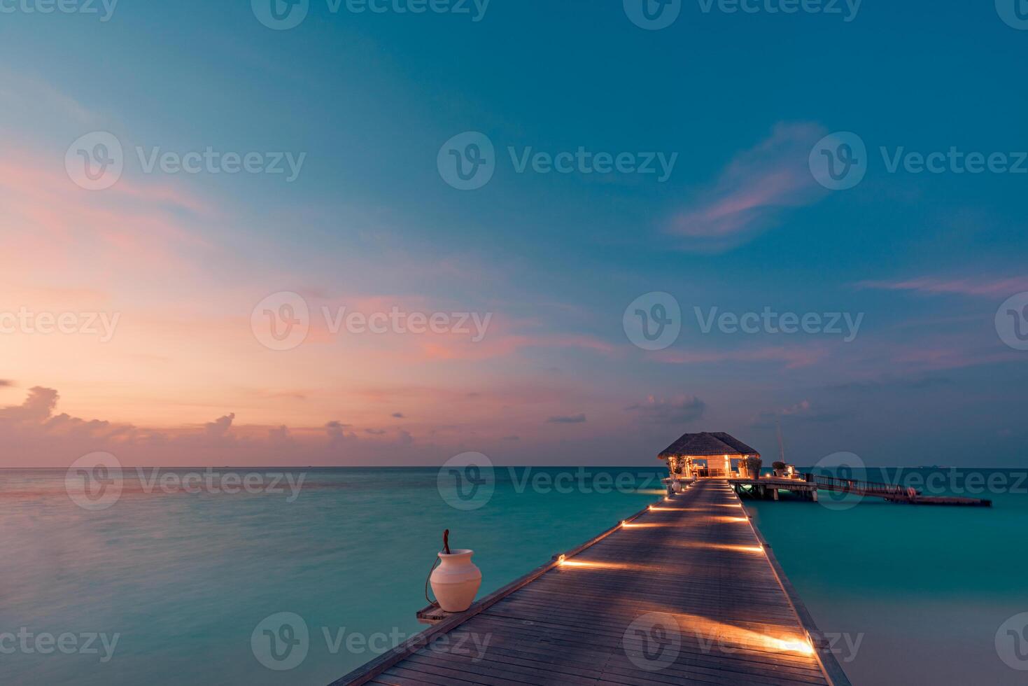 Breathtaking sunset view over water villas surrounded by tranquil ocean waters reflecting vibrant sky hues creating an inspiring tropical landscape perfect relaxation luxury escapes serene island photo
