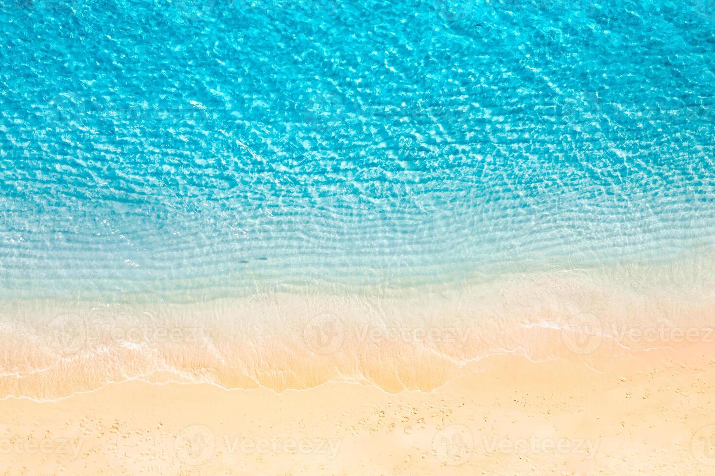 Aerial view of a pristine tropical beach with soft sandy shore and gentle sea waves surrounded by clear turquoise waters creating a serene landscape perfect for relaxation and peaceful escapes photo