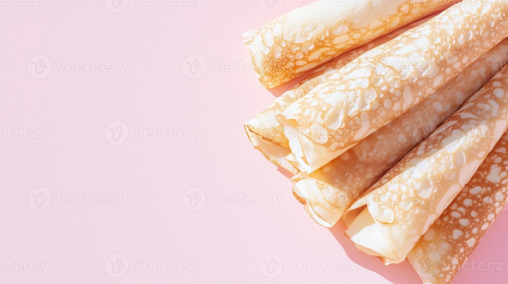 A stack of pancakes on a pink background photo