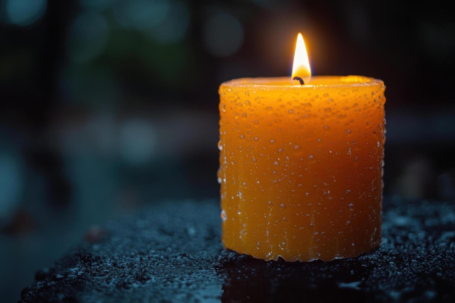 a single candle is lit on a wet surface photo