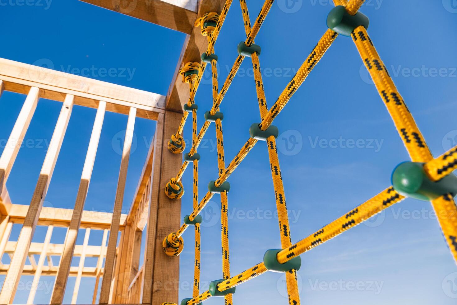 Bright Ropes on an Adventure Playground Structure Against a Clear Blue Sky Create an Inviting Atmosphere for Kids to Explore and Play photo