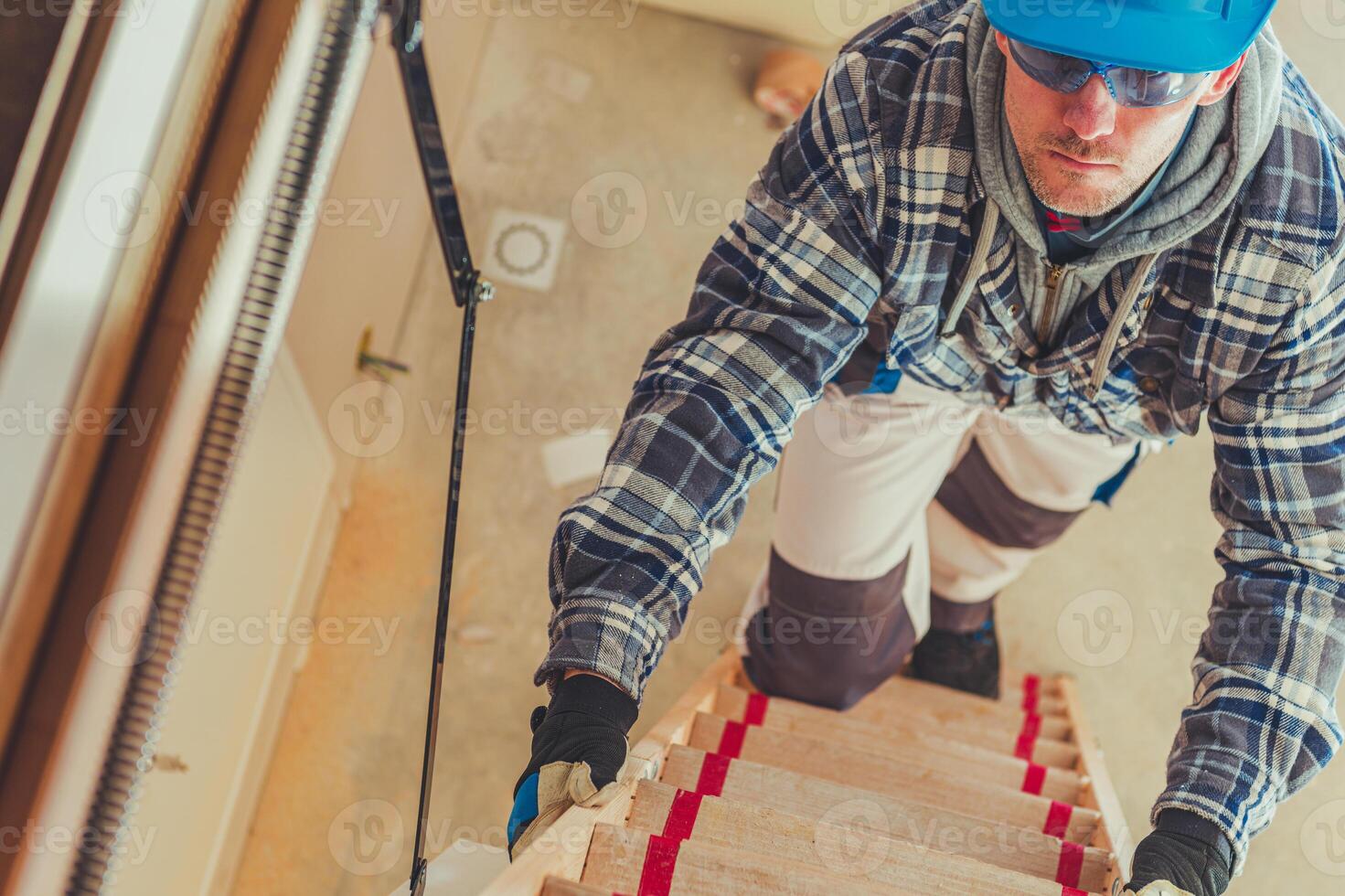 Construction Worker Ascending a Ladder in a Building Under Renovation During Daylight Hours photo