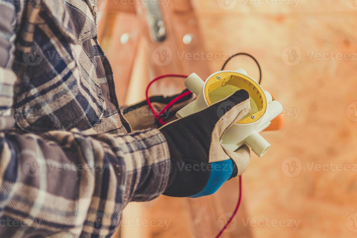 Technician Measures Electrical Current With a Multimeter in a Construction Setting During Daylight Hours photo