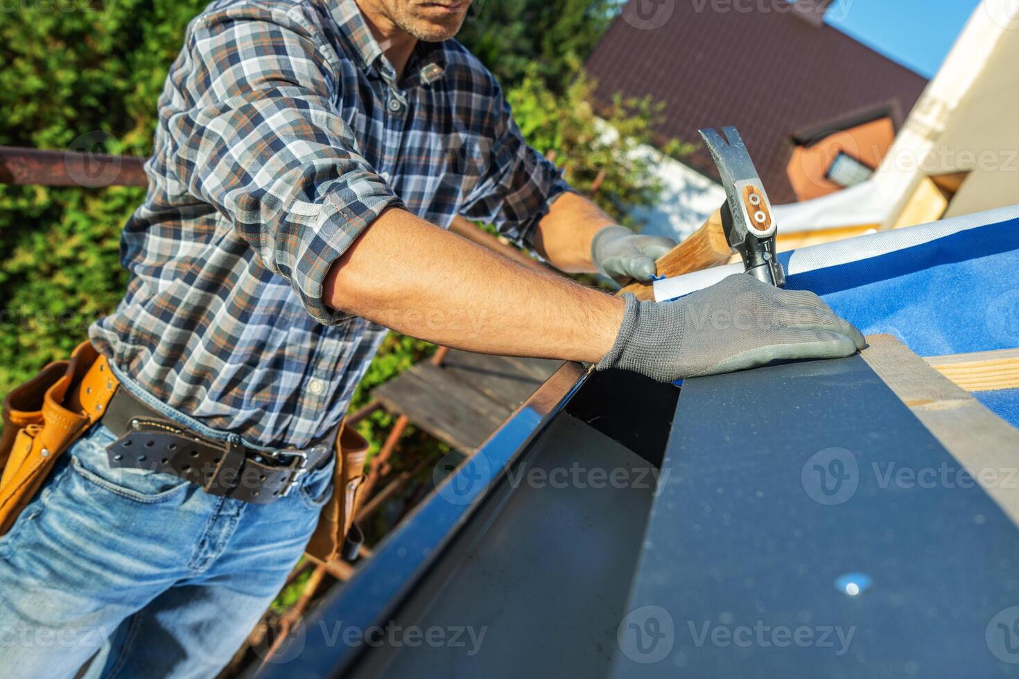 Skilled Carpenter Working on Roof Project in Residential Area During Sunny Day photo