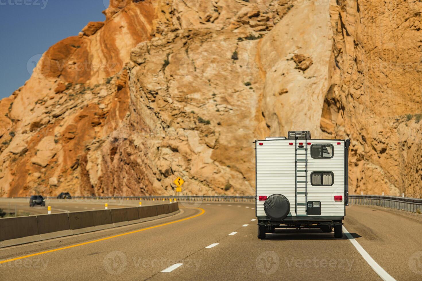 Scenic Utah Road Trip With RV Traveling Through Mountainous Terrain During Clear Daylight photo