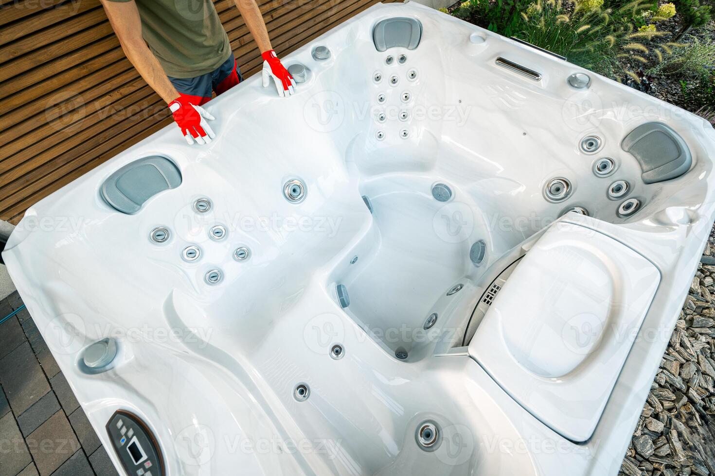 Hot Tub Installation in a Backyard Garden During Daylight With a Focus on the Heating System and Jet Features photo