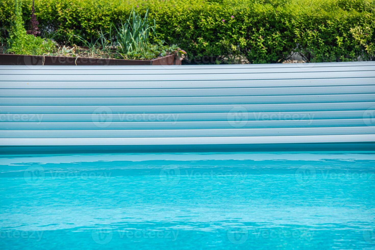 Relaxing Summer Day at a Tranquil Backyard Pool. Plastic Surface Cover photo