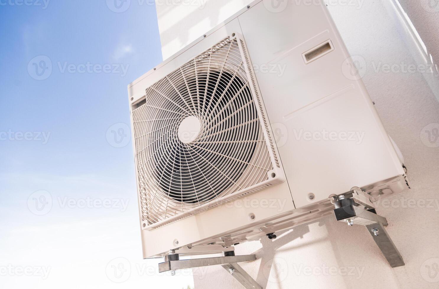 Wall-mounted Air Conditioning Unit in Bright Blue Sky Showcasing Efficient Cooling Technology and Modern Design photo