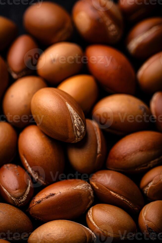 Pile of brown argan nuts texture photo